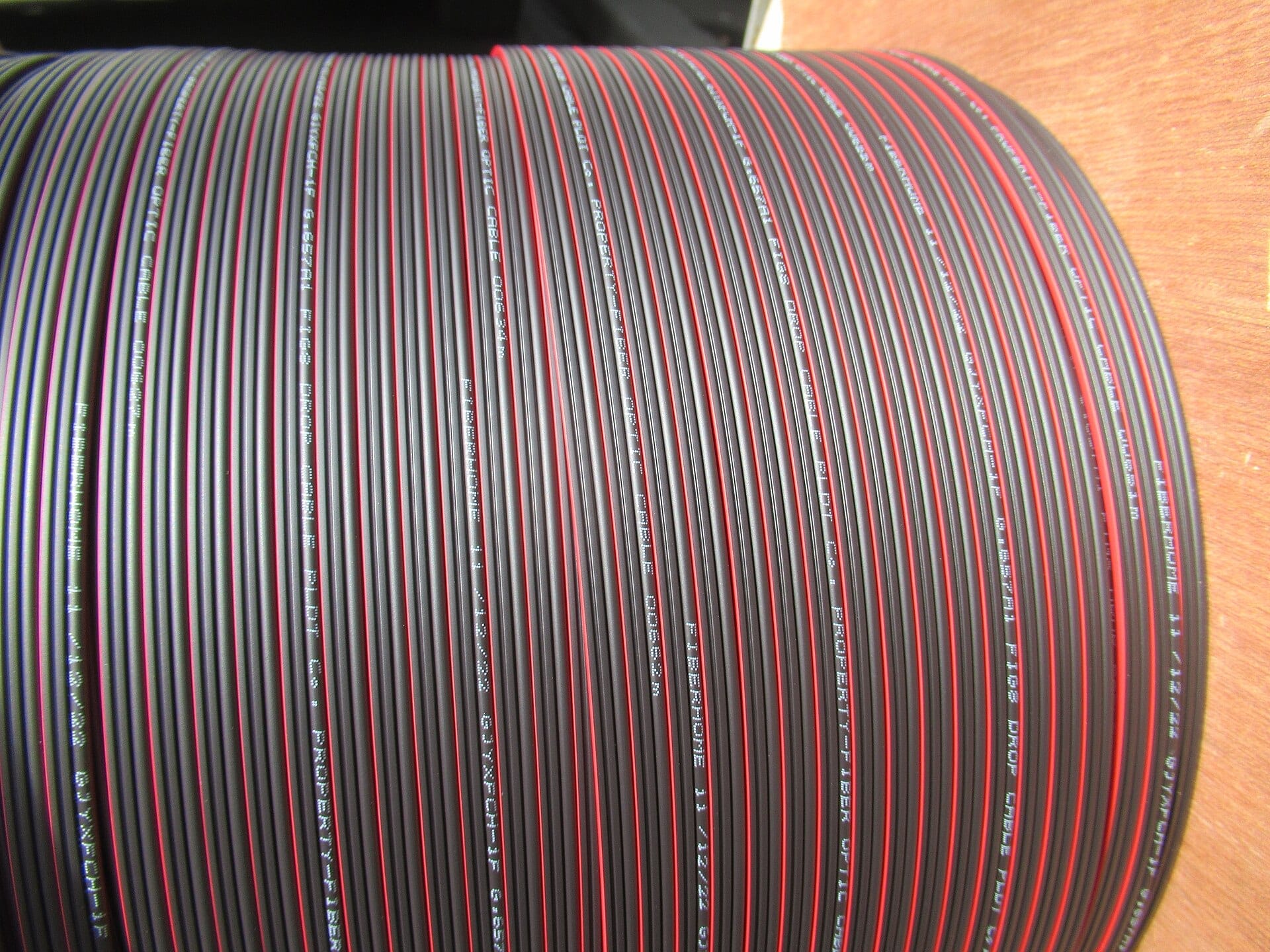 A reel of red and black optical fibre cable