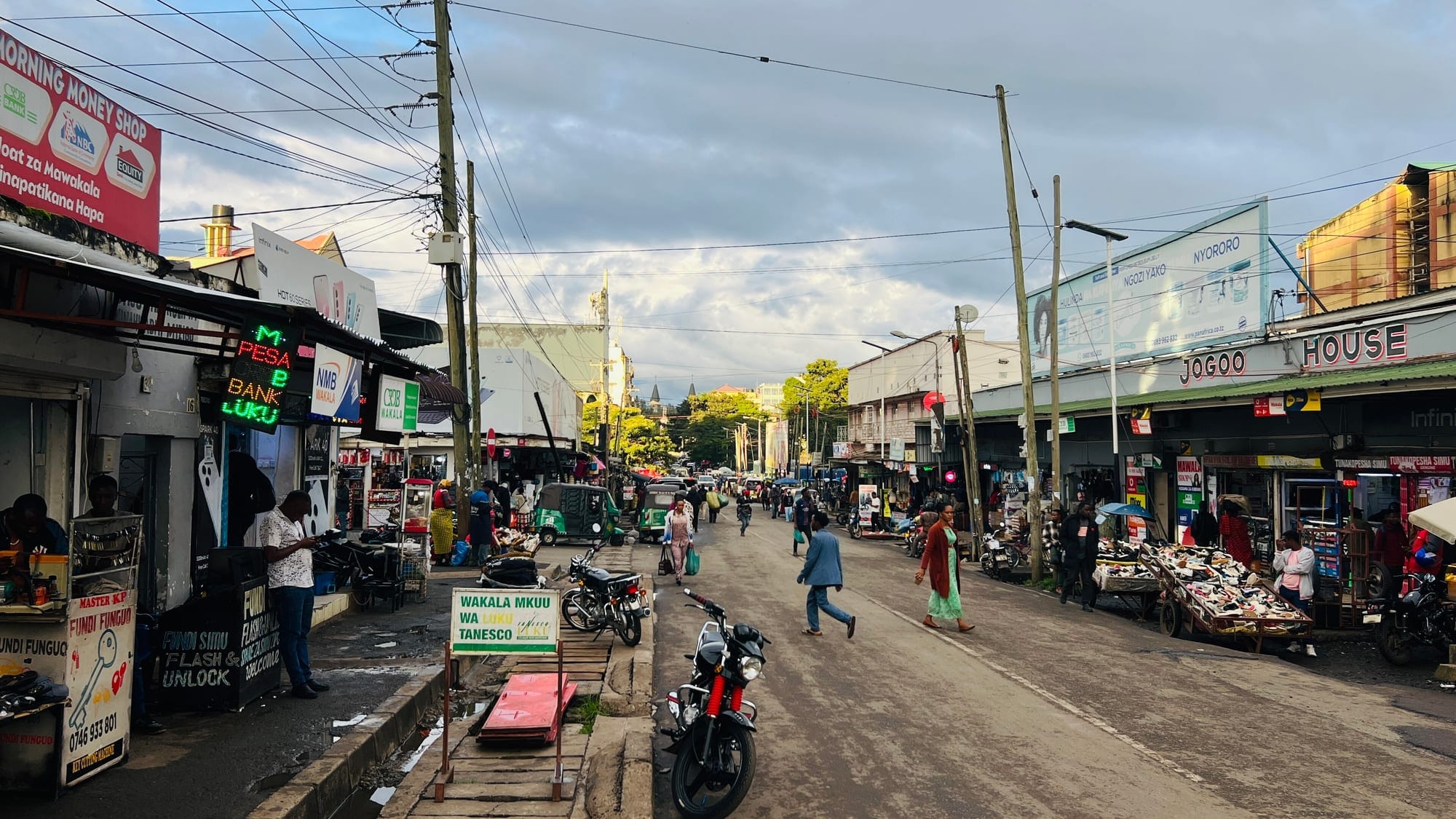 A commercial street in Arusha with M-Pesa and NMB Wakala banking agents